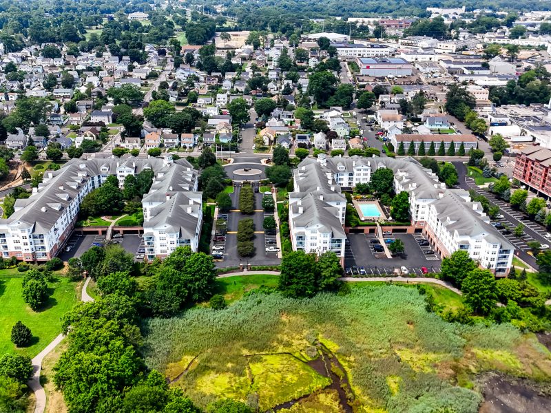Aerial view of TGM Anchor Point apartments with modern buildings, greenery, and suburban neighborhood.