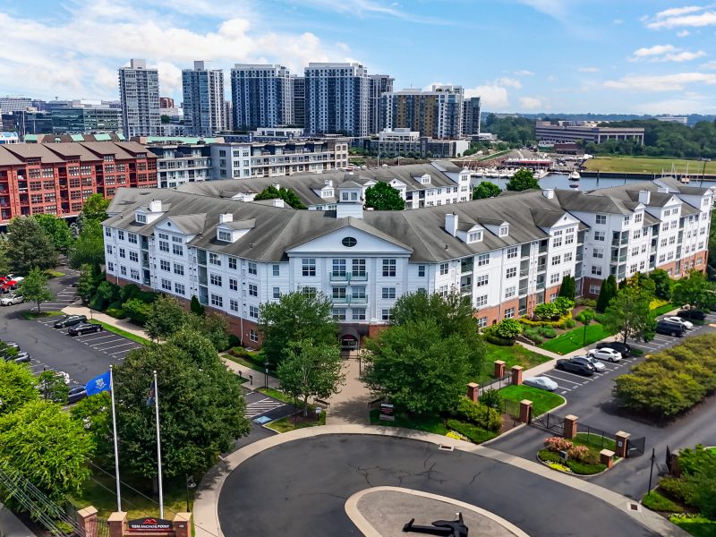 TGM Anchor Point luxury apartments with classical architecture, landscaped greenery, and urban skyline views.