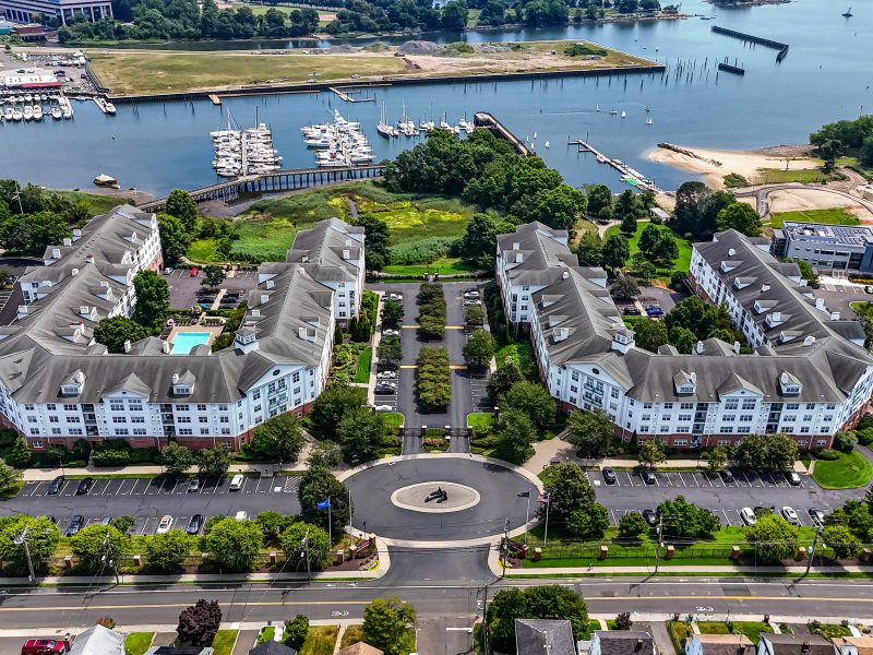 Waterfront residential community at TGM Anchor Point with marina, pool, and modern apartments.