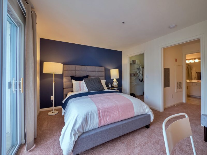 This image shows the bedroom area showcasing the light tone color wall, elegant fabrics, and an overlooking view outside that was ideal for a comfy pleasure.